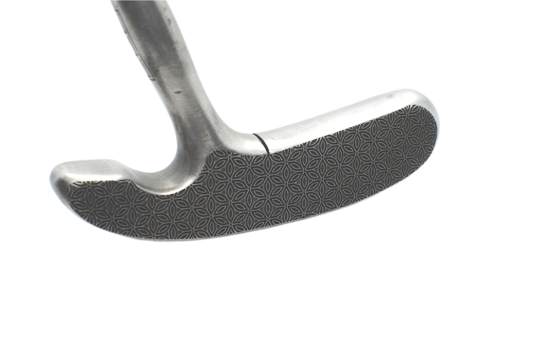 Close-up of a golf putter head on a white background