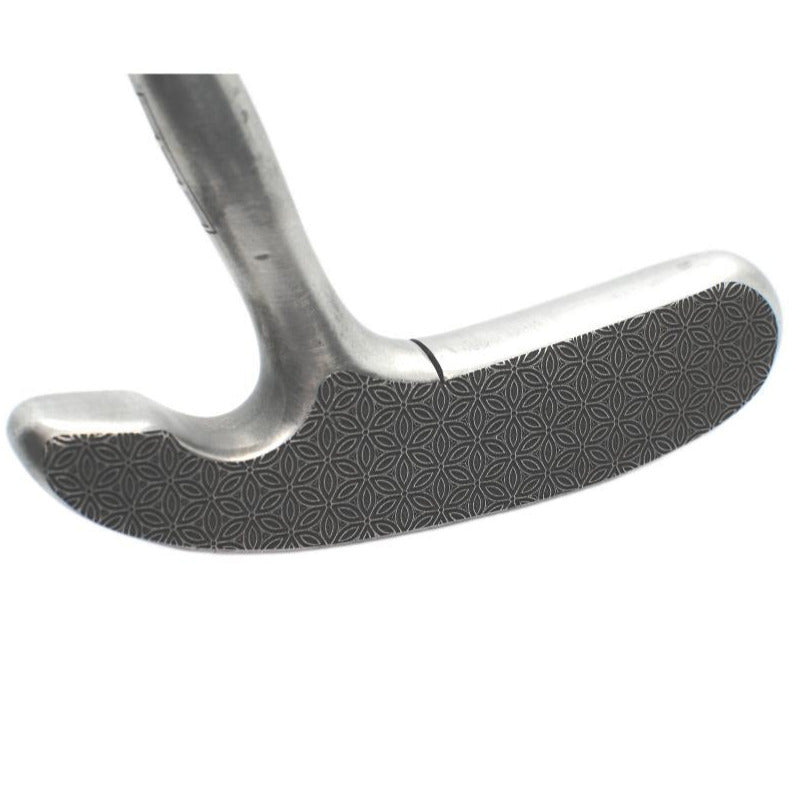 Close-up of a golf club head on a white background
