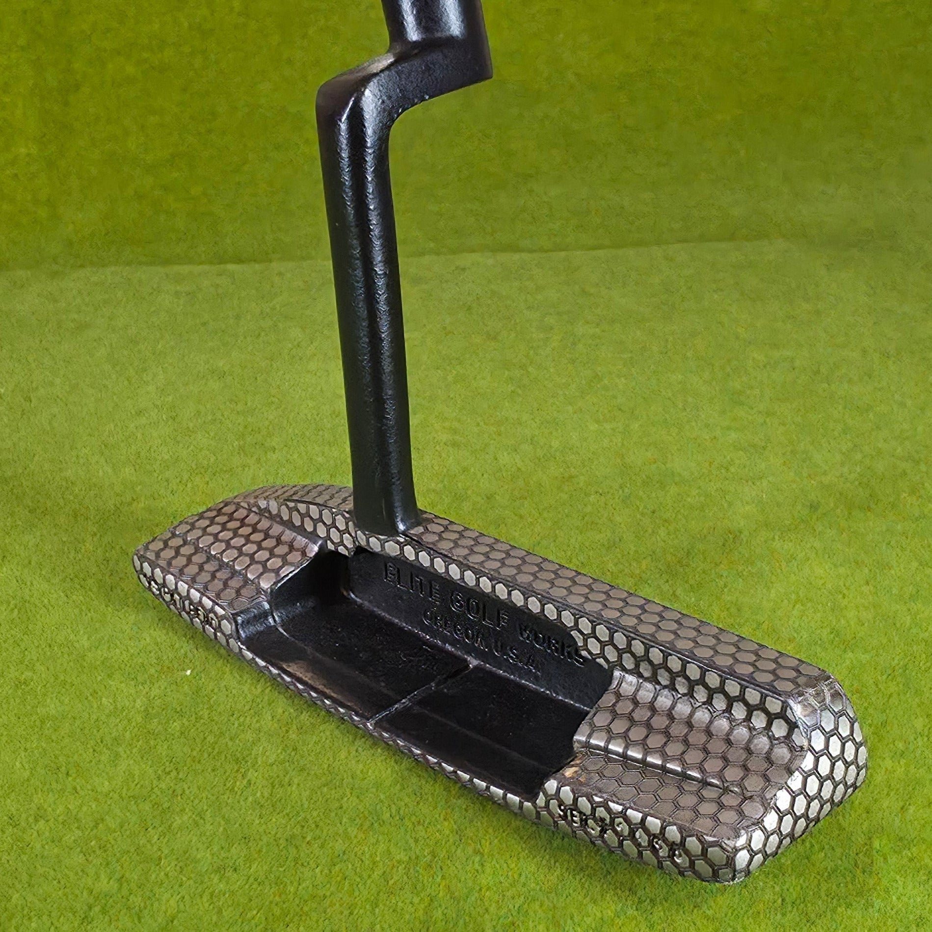 Metallic golf club head cover on a green background