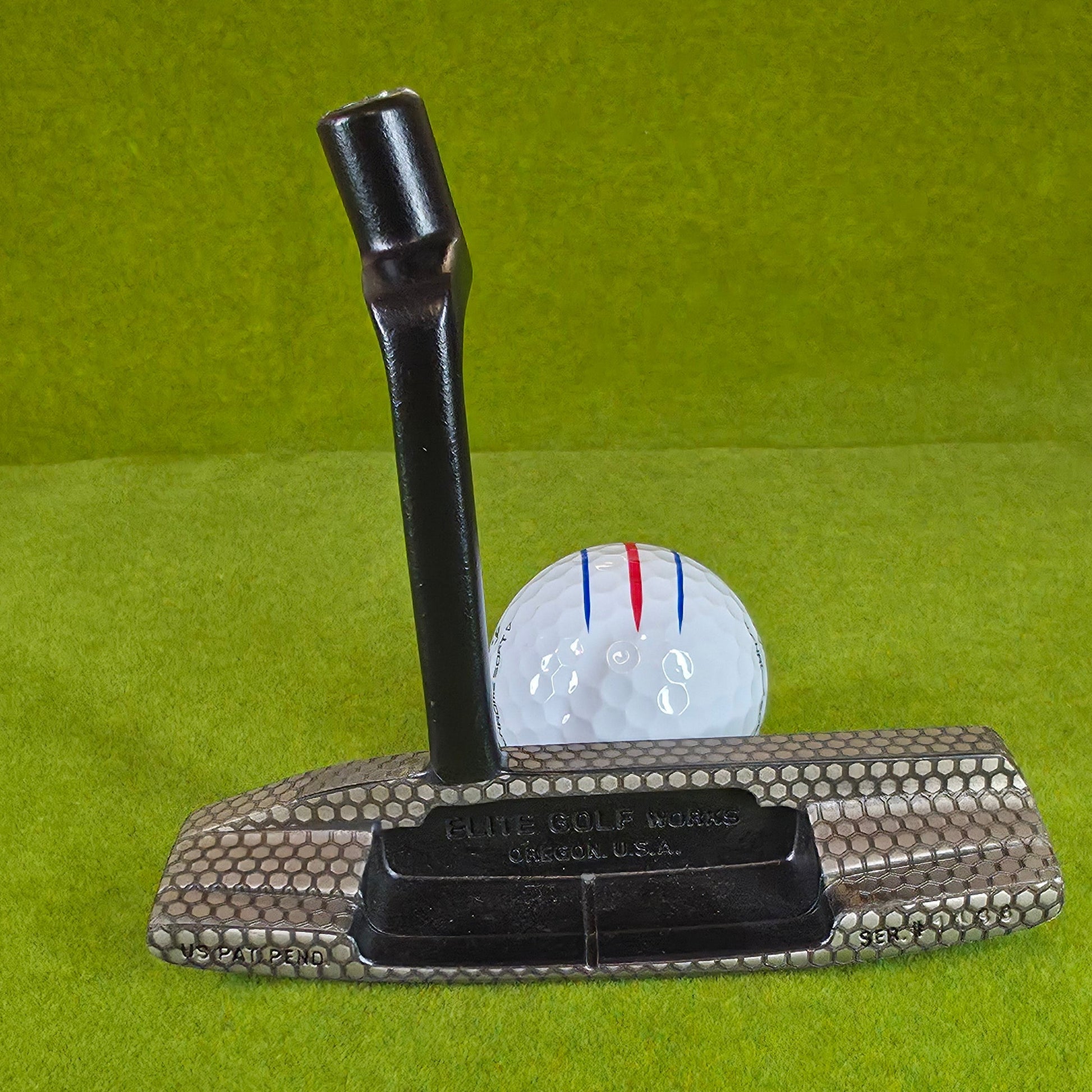 Golf club head cover on a golf ball with a green background
