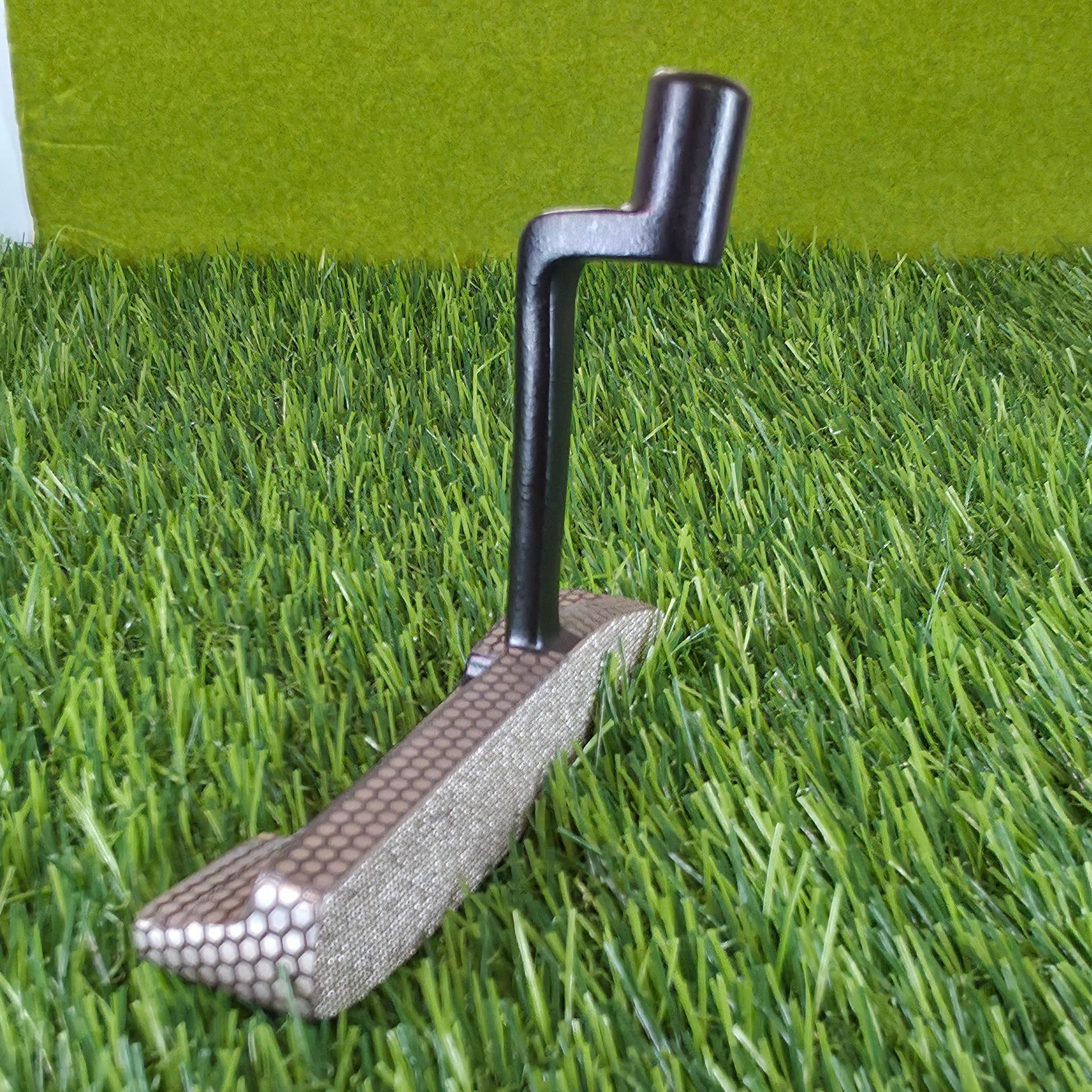 Golf club on a green artificial grass surface