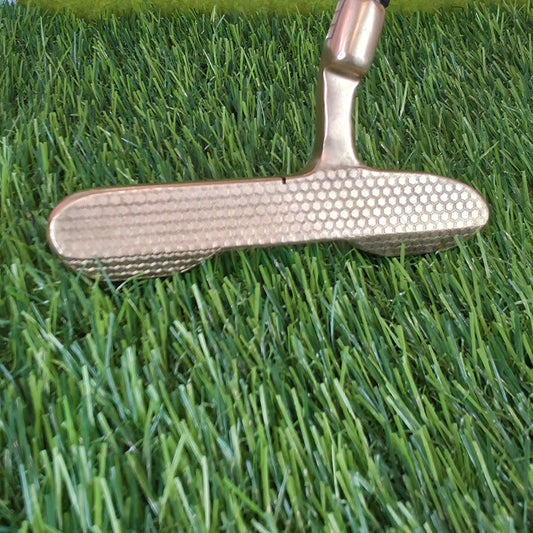 Golf putter on a green putting surface