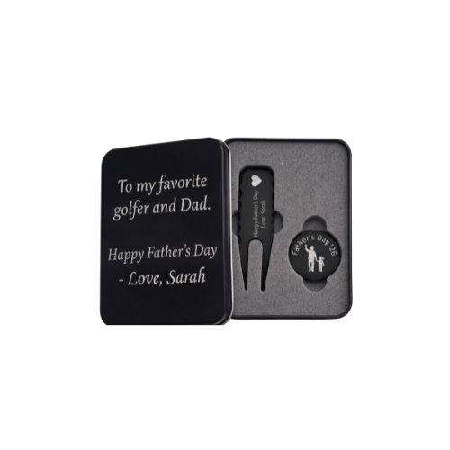 Black metal golf gift set for Father's Day in a custom engraved tin box. Inside sits a customized divot repair tool and a round ball marker resting in foam. Engraving options include sentimental quotes from kids, funny dad golf stats like three-putts, topographic patterns with initials, or classic crossed golf clubs. A perfect personalized fathers or grandpa gift for the golf course. The dark matte metal provides high contrast for the silver laser engraving, making the text pop nicely.