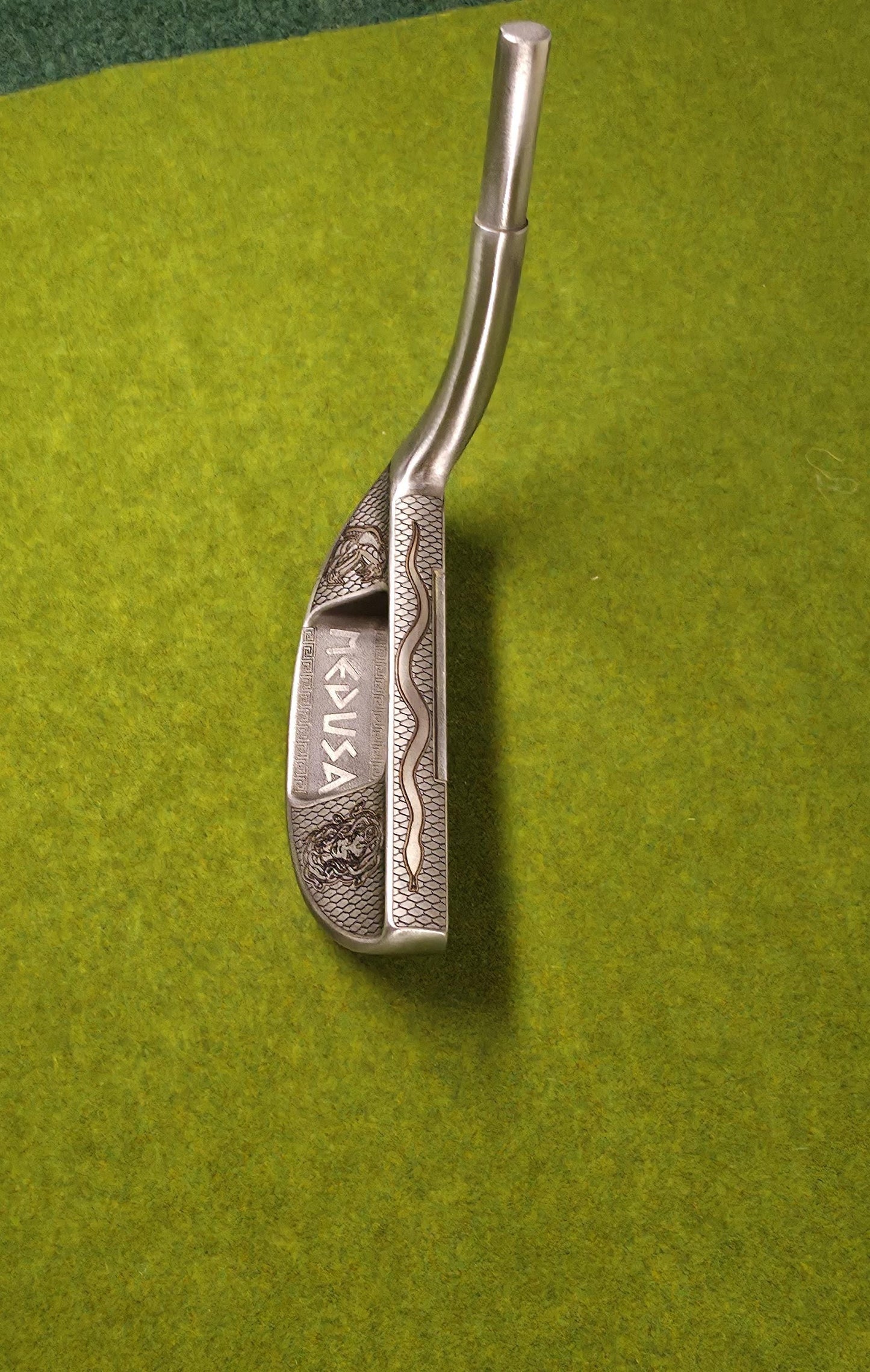 Medusa-inspired engraved Ray Cook Billy Baroo putter with serpent scales, snake engraving, and detailed Medusa face design. Unique mythology-themed golf club that can be played or displayed as a collector’s piece. Custom laser engraved putter ideal for golf enthusiasts, mythology fans, and collectors. Perfect gift for Father’s Day, groomsmen, birthdays, or golf lovers who want a one-of-a-kind club with both style and attitude. medusa golf putter ray cook billy baroo engraved golf putter