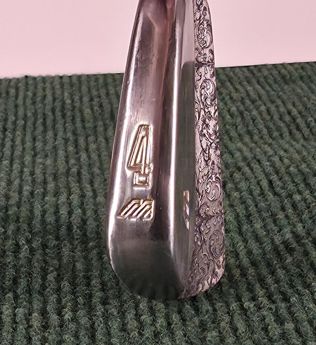 Custom engraved Mizuno 4 Iron with detailed floral scroll pattern. Unique golf club for players, collectors, and as a personalized golf gift. Perfect for Father’s Day, birthdays, weddings, or retirement. Durable steel iron designed for performance with a custom engraved finish. A one-of-a-kind Mizuno golf iron combining artistry and function, making it a standout piece for golf enthusiasts. engraved golf iron
custom mizuno iron
golf gift for him
engraved 4 iron custom golf club unique golf gift