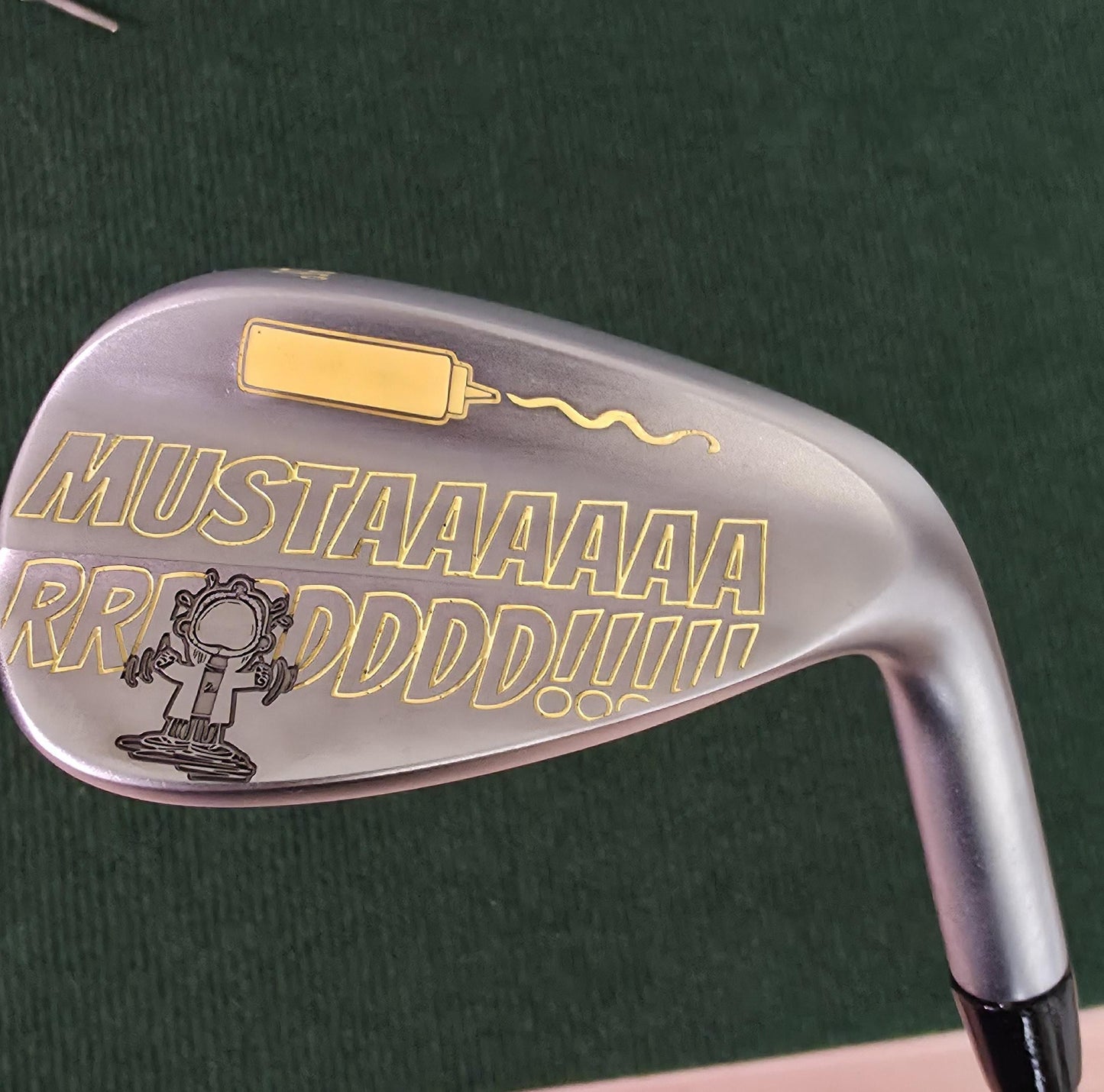 Custom “Mustard” engraved 56-degree golf wedge featuring yellow laser engraving with a mustard bottle and bold “MUSTAAAARRRDD!!!” text. Funny personalized golf club for golfers, collectors, and gift giving. Perfect for Father’s Day, birthdays, or groomsmen. Durable steel wedge designed for both play and laughs, combining humor, performance, and unique custom engraving that stands out on the course.
