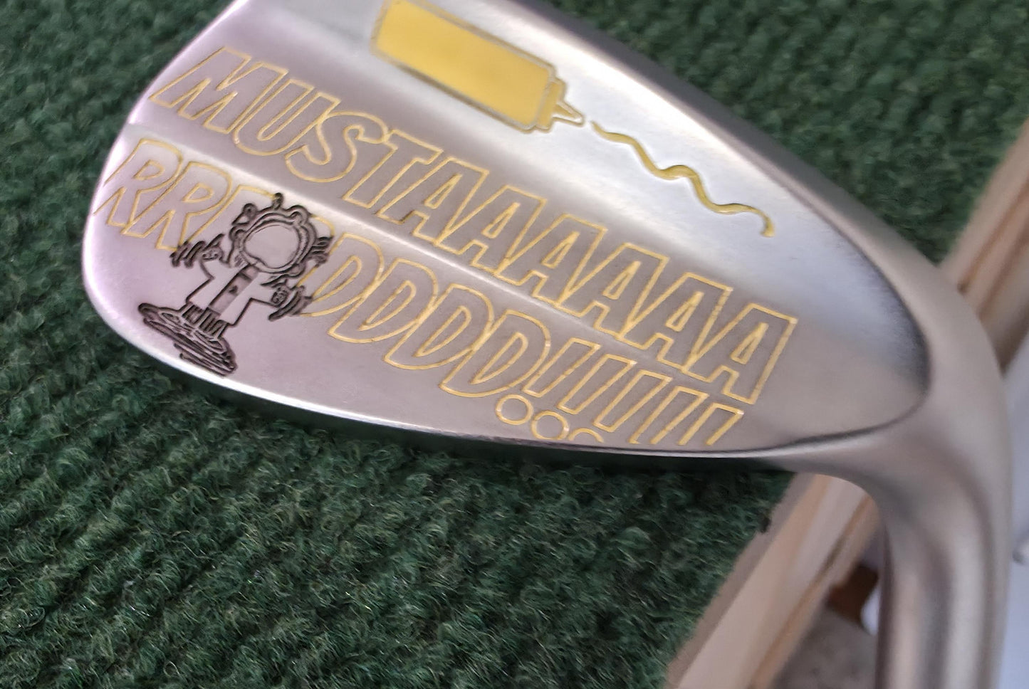 Custom “Mustard” engraved 56-degree golf wedge featuring yellow laser engraving with a mustard bottle and bold “MUSTAAAARRRDD!!!” text. Funny personalized golf club for golfers, collectors, and gift giving. Perfect for Father’s Day, birthdays, or groomsmen. Durable steel wedge designed for both play and laughs, combining humor, performance, and unique custom engraving that stands out on the course.