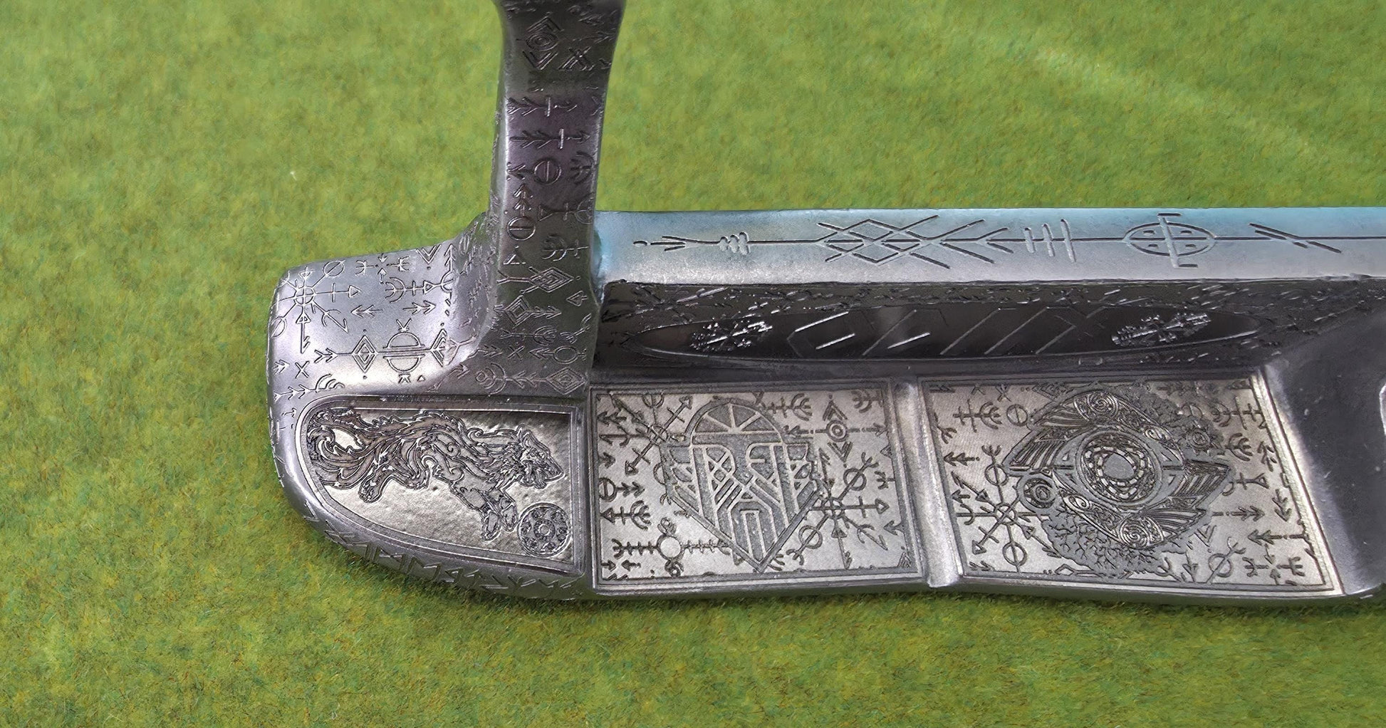 Custom hand-engraved Odin themed golf putter with Norse runes, Viking symbols, and raven designs. Features darkened engravings, raw steel finish, and detailed artwork on the face, back cavity, sole, and neck. Inspired by Norse mythology and Viking craftsmanship. Perfect for golf collectors or players who want a unique personalized putter.