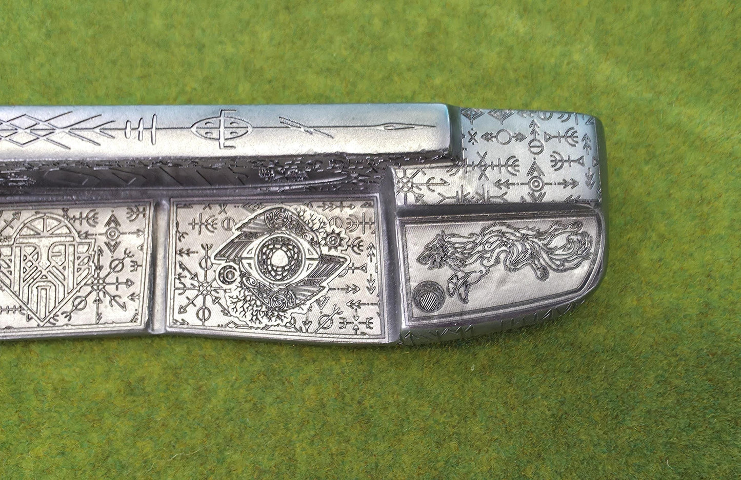 Custom hand-engraved Odin themed golf putter with Norse runes, Viking symbols, and raven designs. Features darkened engravings, raw steel finish, and detailed artwork on the face, back cavity, sole, and neck. Inspired by Norse mythology and Viking craftsmanship. Perfect for golf collectors or players who want a unique personalized putter.