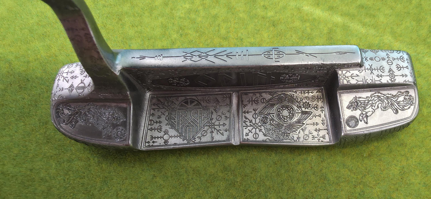 Custom hand-engraved Odin themed golf putter with Norse runes, Viking symbols, and raven designs. Features darkened engravings, raw steel finish, and detailed artwork on the face, back cavity, sole, and neck. Inspired by Norse mythology and Viking craftsmanship. Perfect for golf collectors or players who want a unique personalized putter.