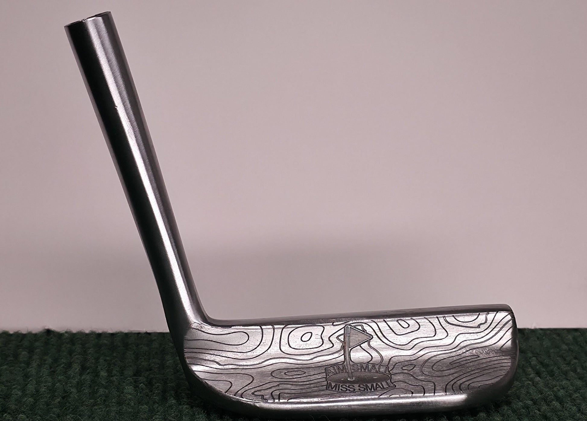 Custom engraved Cleveland Classic putter with topographic map design and “Aim Small Miss Small” phrase. Laser-engraved golf putter for players, collectors, and as a personalized golf gift. Features detailed circle pattern on the putter face for style and performance. Perfect for Father’s Day, birthdays, weddings, or retirement. A unique, functional Cleveland putter that combines artistry with accuracy. engraved golf putter cleveland golf club custom golf putter aim small miss small unique golf